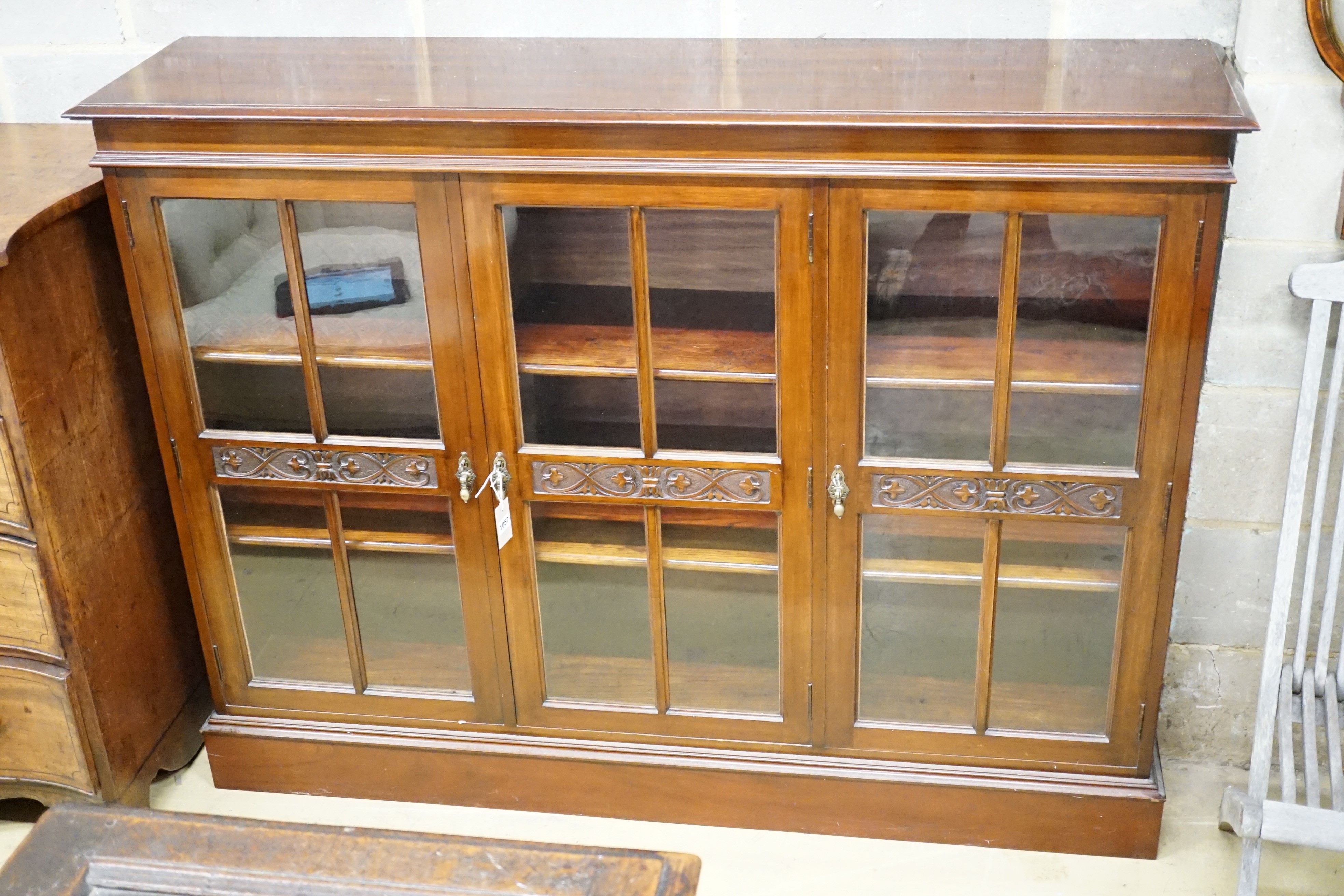 An Edwardian carved mahogany dwarf bookcase, width 153cm, height 116cm